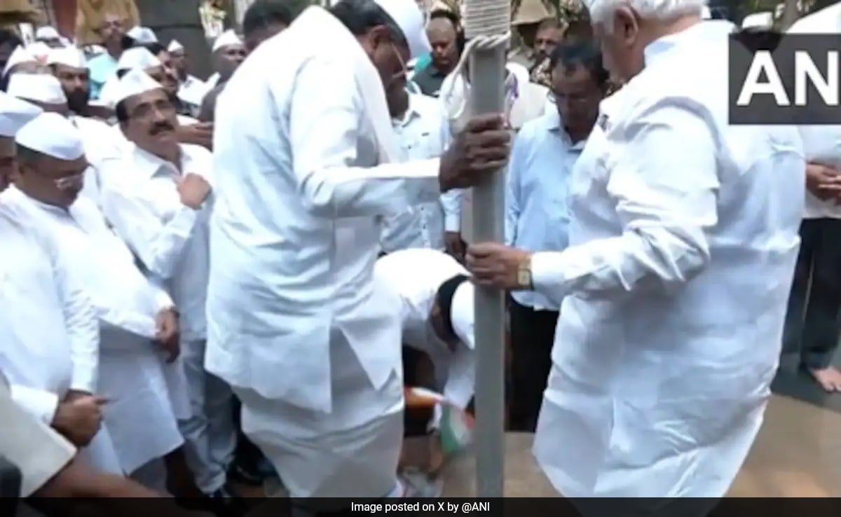 Outrage As Congress Man Takes Off Siddaramaiah’s Shoes Holding Tricolour